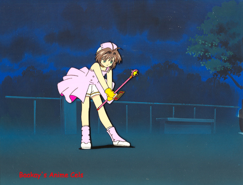 Sakura, in the darkened playground, is just about to activate one of her cards.
